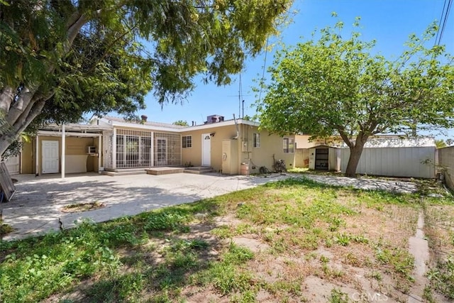 9451 Canterbury Ave, Arleta, CA 91331 - back of property with a patio area, fence, and stucco siding