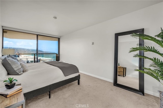 531 Esplanade Unit 714, Redondo Beach, CA 90277 - bedroom with light carpet, baseboards, and expansive windows