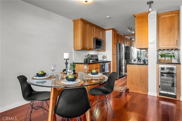 531 Esplanade Unit 714, Redondo Beach, CA 90277 - kitchen featuring appliances with stainless steel finishes, beverage cooler, backsplash, dark countertops, and dark wood-style floors