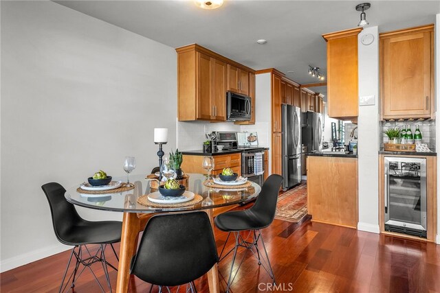 531 Esplanade Unit 714, Redondo Beach, CA 90277 - kitchen with beverage cooler, stainless steel appliances, backsplash, dark countertops, and dark wood-style flooring