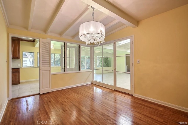 interior space featuring beamed ceiling and a chandelier