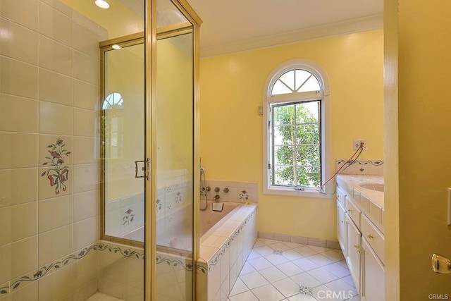 bathroom featuring tile patterned flooring, ornamental molding, a shower stall, and a garden tub