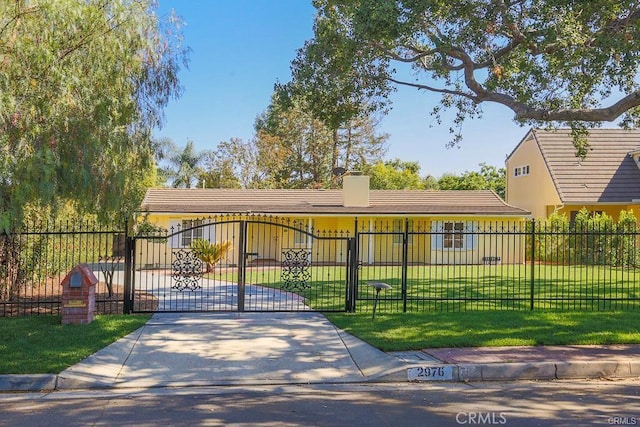 view of gate featuring a fenced front yard and a yard