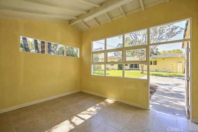 unfurnished sunroom with beamed ceiling