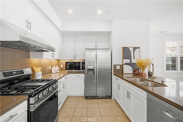 65 Tallowood, Irvine, CA 92620 - kitchen with appliances with stainless steel finishes, a sink, white cabinets, light tile patterned floors, and recessed lighting