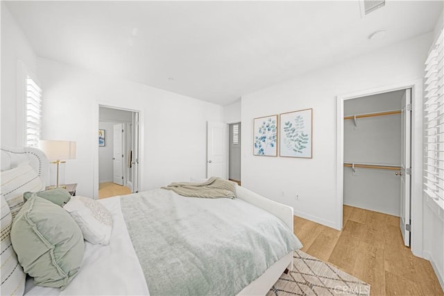 65 Tallowood, Irvine, CA 92620 - bedroom featuring light wood-style flooring, a spacious closet, and a closet