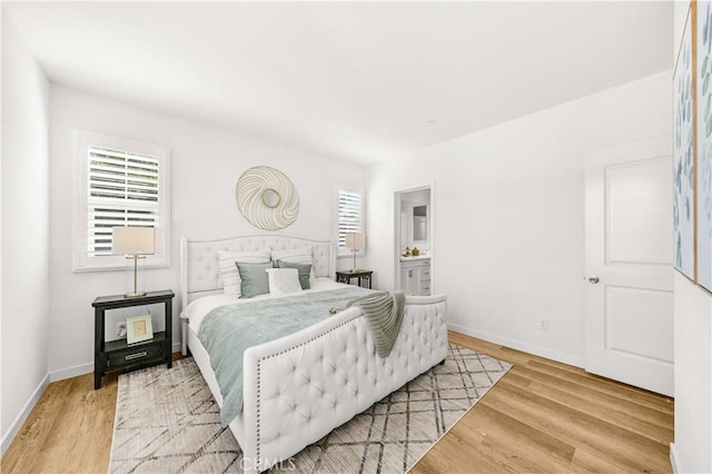 65 Tallowood, Irvine, CA 92620 - bedroom featuring light wood-style flooring, multiple windows, and baseboards