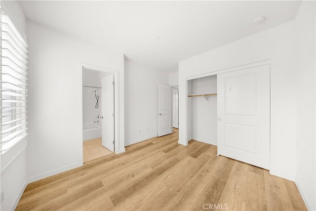 65 Tallowood, Irvine, CA 92620 - unfurnished bedroom with light wood finished floors, a closet, and baseboards