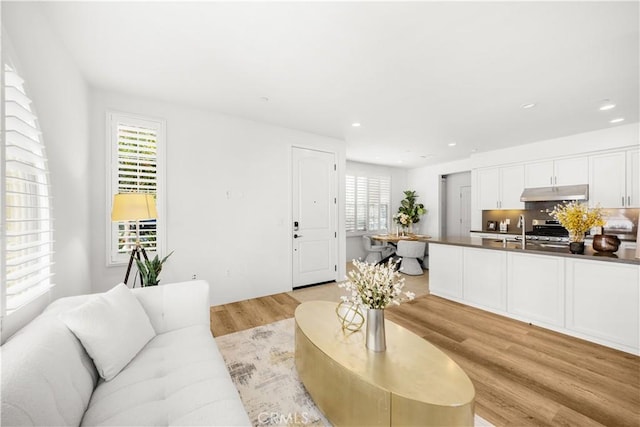 65 Tallowood, Irvine, CA 92620 - living area with light wood-type flooring and recessed lighting