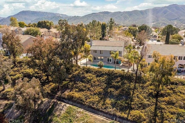 view from above of property with a pool and a mountainous background