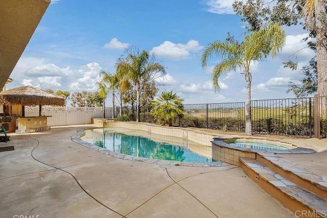 view of pool featuring an in-ground hot tub, a patio area, and a fenced backyard