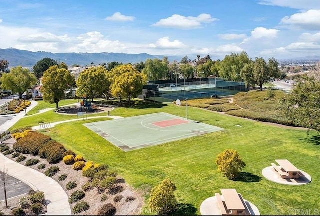 view of sport court with community basketball court, a tennis court, and a mountain view