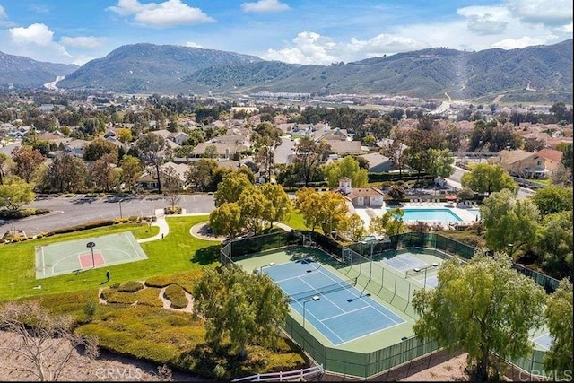 bird's eye view of a mountainous background and a pool area