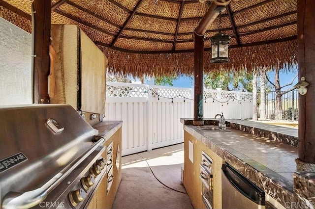 view of patio / terrace featuring a gazebo, grilling area, area for grilling, fence, and a sink