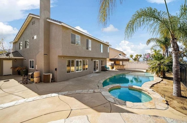 view of pool featuring a fenced backyard, a patio area, and a pool with connected hot tub