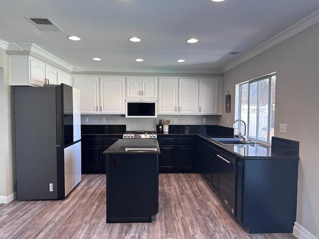 42944 Calle Reva, Temecula, CA 92592 - kitchen featuring freestanding refrigerator, dark countertops, a sink, range, and crown molding