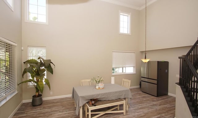 42944 Calle Reva, Temecula, CA 92592 - dining space with stairway, a towering ceiling, wood finished floors, ornamental molding, and healthy amount of natural light