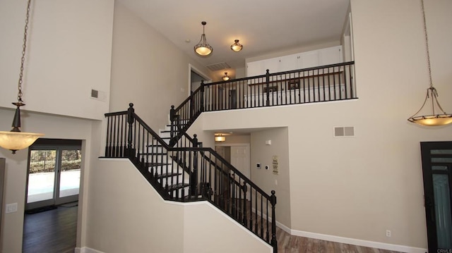 42944 Calle Reva, Temecula, CA 92592 - stairs with wood finished floors, a high ceiling, and baseboards