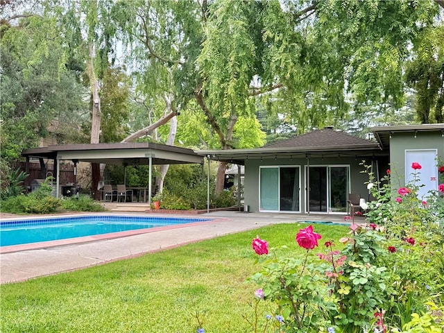 pool featuring a patio area and a yard
