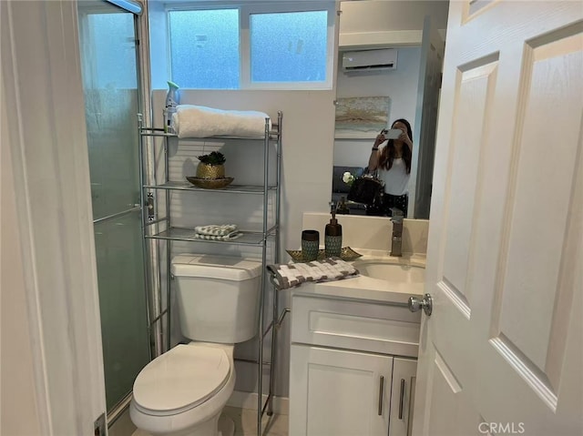 bathroom featuring vanity, a wall mounted AC, and toilet
