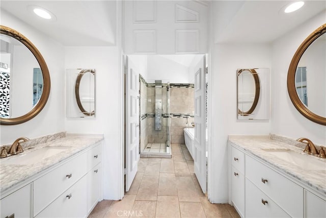 full bathroom featuring a stall shower, two vanities, tile patterned flooring, recessed lighting, and a freestanding bath