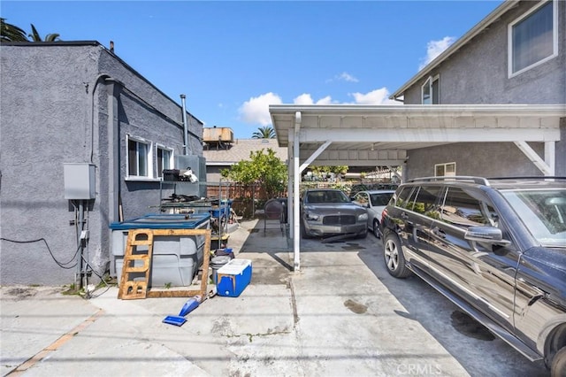 844W 105th St, Los Angeles, CA 90044 - view of vehicle parking with an attached carport and driveway