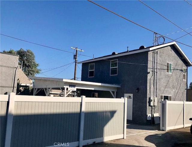 844W 105th St, Los Angeles, CA 90044 - view of side of property featuring fence and stucco siding