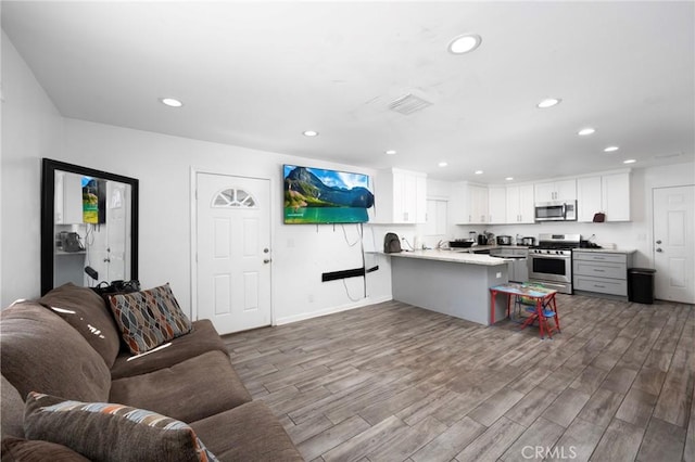 844W 105th St, Los Angeles, CA 90044 - living room featuring wood finished floors, recessed lighting, and baseboards