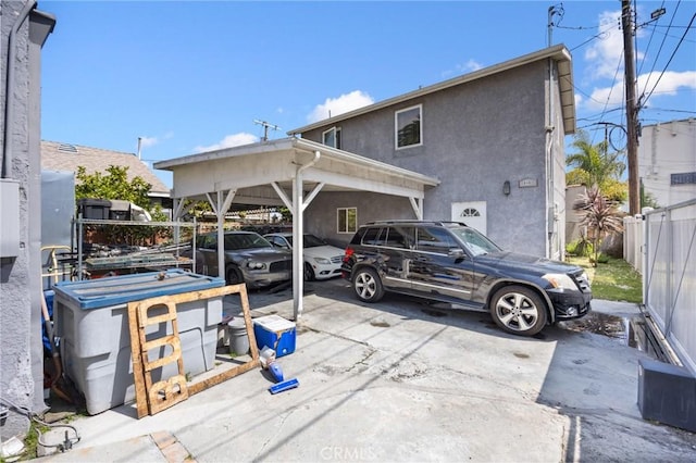 844W 105th St, Los Angeles, CA 90044 - view of parking with fence and a carport