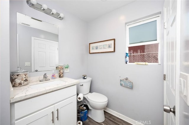 844W 105th St, Los Angeles, CA 90044 - bathroom featuring vanity, toilet, baseboards, and wood finished floors