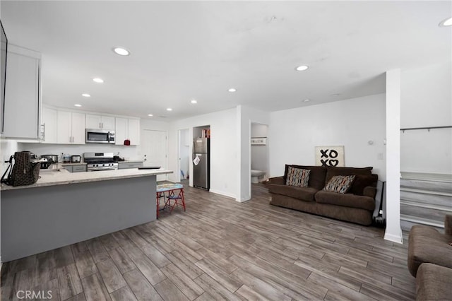844W 105th St, Los Angeles, CA 90044 - living room featuring recessed lighting, wood finished floors, and baseboards