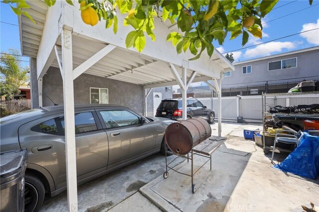 844W 105th St, Los Angeles, CA 90044 - view of vehicle parking featuring a carport, fence, and a gate