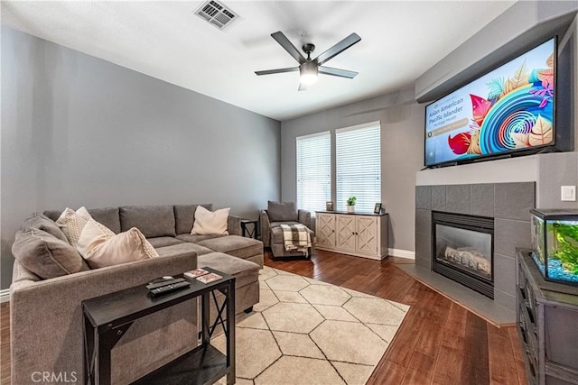 7 Burlingame Ln, Aliso Viejo, CA 92656 - living room featuring wood finished floors, a tile fireplace, a ceiling fan, and baseboards
