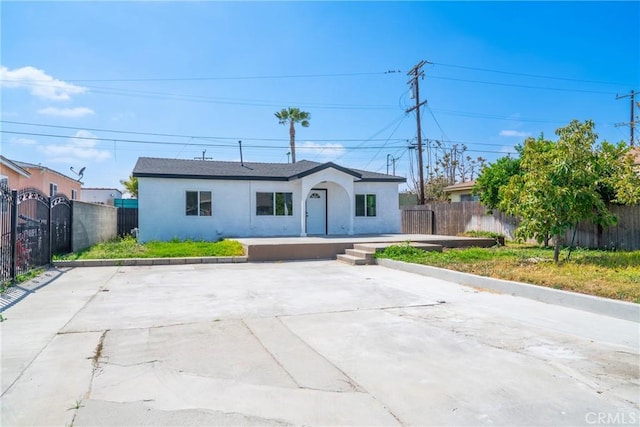 view of front of home featuring fence and stucco siding