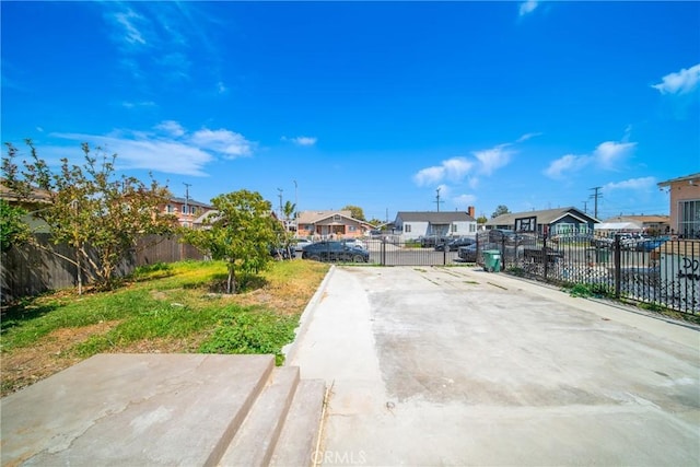 view of patio featuring fence and a residential view