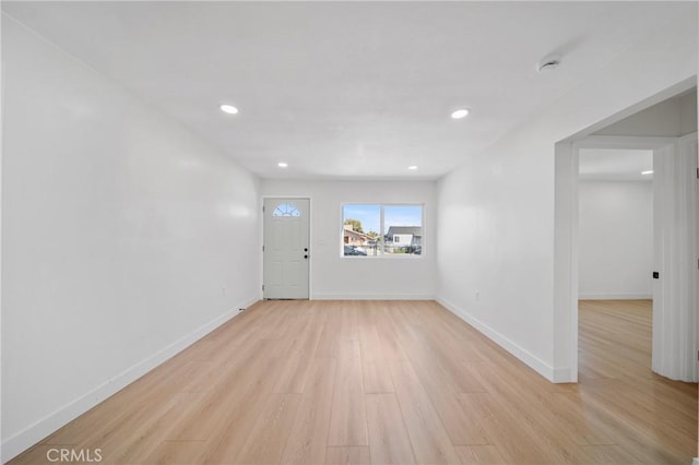 interior space featuring light wood-style floors, baseboards, and recessed lighting