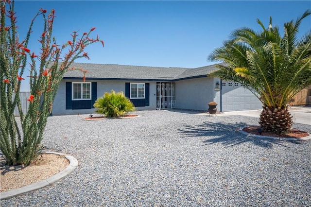 ranch-style home with stucco siding, a garage, and concrete driveway