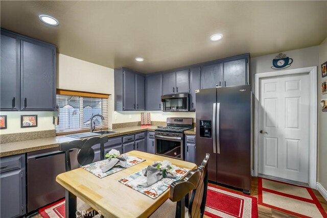 kitchen with stainless steel appliances, recessed lighting, and wood finished floors