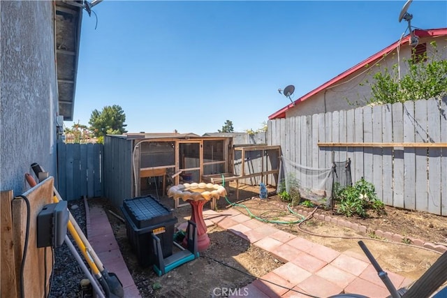 fenced backyard with exterior structure