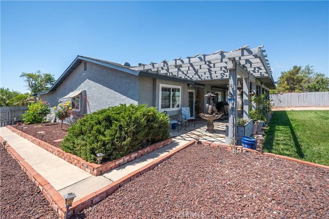 view of side of home featuring a patio, stucco siding, and a pergola