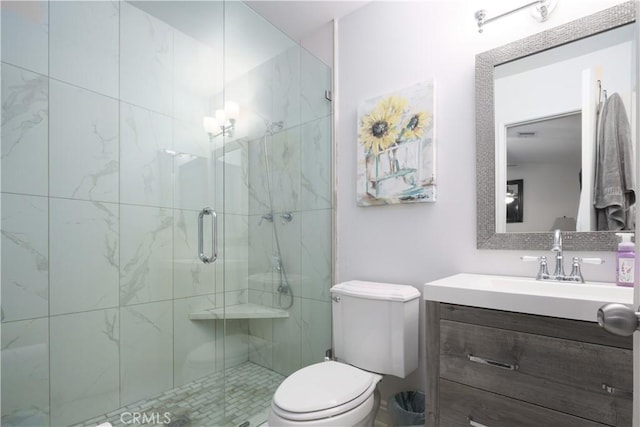 full bathroom with a stall shower, toilet, and vanity