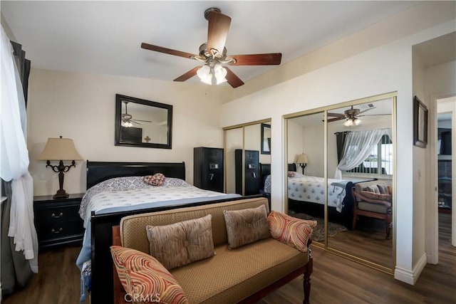 bedroom featuring wood finished floors, multiple closets, and ceiling fan