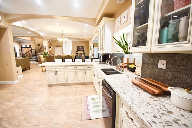 11331 Chapman Ave, Garden Grove, CA 92840 - kitchen featuring a sink, dishwashing machine, light stone counters, a peninsula, and arched walkways
