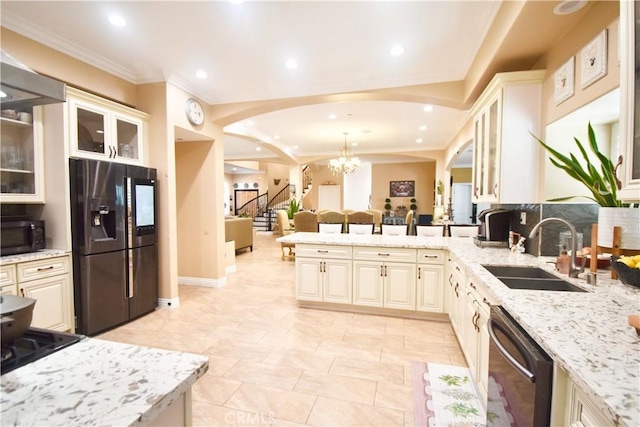 11331 Chapman Ave, Garden Grove, CA 92840 - kitchen with black appliances, a sink, a peninsula, light stone counters, and a chandelier
