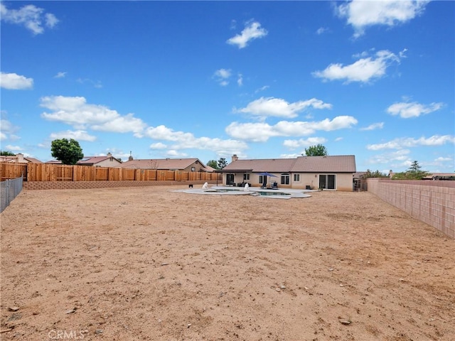 rear view of house featuring a patio, a fenced in pool, and a fenced backyard