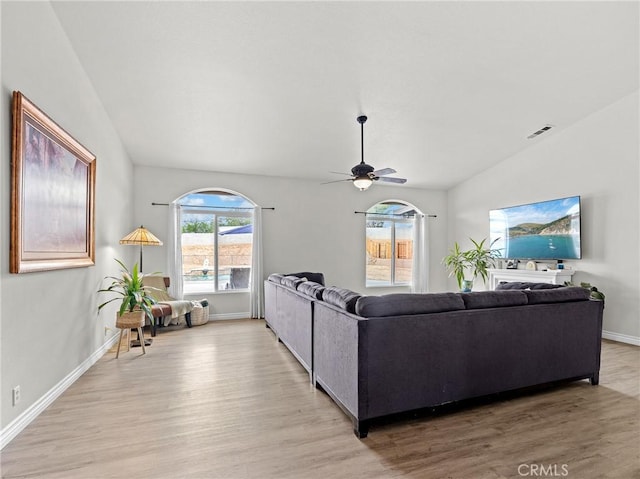 living room with baseboards, ceiling fan, visible vents, and light wood-style flooring