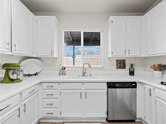 kitchen featuring a sink, light countertops, white cabinets, and stainless steel dishwasher