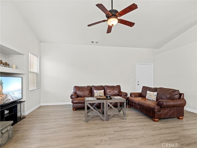 living area with a ceiling fan, light wood-type flooring, lofted ceiling, and visible vents