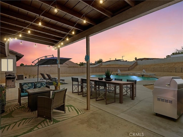 patio terrace at dusk featuring a fenced in pool, a fenced backyard, outdoor dining area, and area for grilling