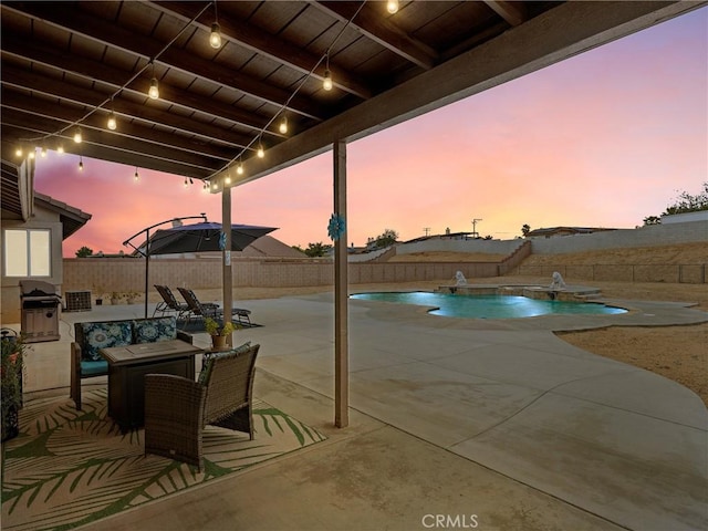 patio terrace at dusk with a fenced in pool and a fenced backyard